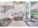 Spacious living room with high ceilings, staircase, and view into the kitchen and outdoor patio at 3722 Somerset Nw Rdg, Kennesaw, GA 30144