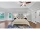 Large main bedroom with wood floors, ceiling fan, and bedside tables with lamps at 3722 Somerset Nw Rdg, Kennesaw, GA 30144