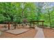 Community playground featuring swings and a covered seating area amidst lush greenery at 3722 Somerset Nw Rdg, Kennesaw, GA 30144