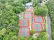 Aerial view of community tennis courts and swimming pool surrounded by lush forest at 3722 Somerset Nw Rdg, Kennesaw, GA 30144