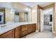 Bathroom with dual sinks, wood cabinets, and large mirror at 3901 High Dove Sw Way # 17, Smyrna, GA 30082