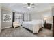 Bright main bedroom with tray ceiling, ceiling fan, large windows, and sitting area at 3901 High Dove Sw Way # 17, Smyrna, GA 30082