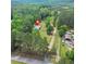 An aerial view of a home on a sprawling lot surrounded by mature trees and lush greenery at 415 Gray Rd, Carrollton, GA 30116