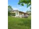 The backyard of a home with a covered porch, a wooden deck, and a large grassy area at 415 Gray Rd, Carrollton, GA 30116