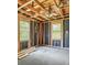 Unfinished bedroom with two windows, exposed framing, and ceiling fan at 415 Gray Rd, Carrollton, GA 30116