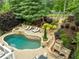 Aerial view of a pool, waterfall, fireplace, and landscaping at 1657 Millhouse Lndg, Marietta, GA 30066