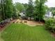 Expansive backyard featuring a lush green lawn, patio area, and garden beds for outdoor enjoyment at 1657 Millhouse Lndg, Marietta, GA 30066