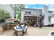 The backyard includes an outdoor kitchen, a dining space, hot tub, and a spiral staircase to access the upper-level balcony at 1657 Millhouse Lndg, Marietta, GA 30066