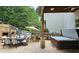 Backyard featuring outdoor kitchen, dining area, stone fireplace, and hot tub for ultimate outdoor entertaining at 1657 Millhouse Lndg, Marietta, GA 30066
