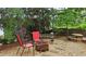 Backyard area with a fire pit, seating, string lights, and a hammock for relaxing outdoors at 1657 Millhouse Lndg, Marietta, GA 30066