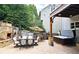 This backyard features an outdoor kitchen, hot tub, stone fireplace, umbrella-shaded dining, and a seating area at 1657 Millhouse Lndg, Marietta, GA 30066