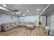 Finished basement featuring wood flooring, a large sectional sofa and a play area at 1657 Millhouse Lndg, Marietta, GA 30066