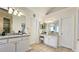 Bright bathroom featuring dual vanities, neutral tile flooring and modern fixtures at 1657 Millhouse Lndg, Marietta, GA 30066