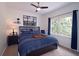 Cozy bedroom with natural light, with carpeted floors and neutral paint, ceiling fan, and a large window at 1657 Millhouse Lndg, Marietta, GA 30066