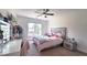 Bright bedroom with a ceiling fan, large window, and desk with vanity lighting at 1657 Millhouse Lndg, Marietta, GA 30066