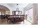 Open-concept dining area with hardwood floors, a large table, and views to the kitchen at 1657 Millhouse Lndg, Marietta, GA 30066