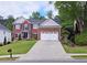 Charming brick home with a long driveway leading to an attached two-car garage at 1657 Millhouse Lndg, Marietta, GA 30066