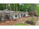 Backyard garden setup with a greenhouse, gardening table, and raised garden beds for cultivating plants at 1657 Millhouse Lndg, Marietta, GA 30066