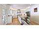 Bright open kitchen with large center island with marble countertops, white cabinets, and stainless steel appliances at 1657 Millhouse Lndg, Marietta, GA 30066