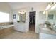 Well-appointed main bathroom with soaking tub, double vanity, and walk-in closet at 1657 Millhouse Lndg, Marietta, GA 30066