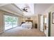 Spacious main bedroom features tray ceilings, a ceiling fan, and access to a private deck at 1657 Millhouse Lndg, Marietta, GA 30066