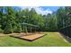 Playground under a canopy adds a playful touch to this property's outdoor amenities at 1657 Millhouse Lndg, Marietta, GA 30066