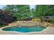Beautiful pool and waterfall surrounded by lush landscaping create a serene backyard retreat at 1657 Millhouse Lndg, Marietta, GA 30066