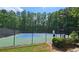 Community tennis court with fencing and lush greenery, providing a recreational amenity for residents at 1657 Millhouse Lndg, Marietta, GA 30066