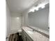Well-lit bathroom features a combination shower and tub, granite vanity top, and sleek vanity mirror at 19 Loth Wages (Lot 19) Rd, Dacula, GA 30019