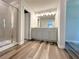 Bathroom featuring new flooring, a glass shower, and a granite sink at 19 Loth Wages (Lot 19) Rd, Dacula, GA 30019
