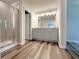 Bathroom featuring new flooring, a glass shower, and a granite sink at 19 Loth Wages (Lot 19) Rd, Dacula, GA 30019