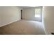 Spacious bedroom features neutral walls, carpet flooring, and window for plenty of natural light at 19 Loth Wages (Lot 19) Rd, Dacula, GA 30019