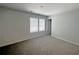 Bright bedroom features neutral walls, carpet flooring, and a double window for natural light at 19 Loth Wages (Lot 19) Rd, Dacula, GA 30019