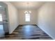 Dining room with modern chandelier, wood floors, and views of the backyard at 19 Loth Wages (Lot 19) Rd, Dacula, GA 30019