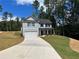 Charming two-story home with gray siding, a two-car garage, and a newly paved driveway at 19 Loth Wages (Lot 19) Rd, Dacula, GA 30019