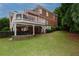 Lovely brick home featuring an ample green backyard with a charming covered patio and upper level deck at 2174 Basque Se Dr, Smyrna, GA 30080