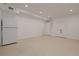 Spacious basement featuring neutral color walls and flooring, with access to closets and a refrigerator at 2174 Basque Se Dr, Smyrna, GA 30080