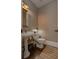 Cozy half-bathroom features a pedestal sink, classic fixtures, and a neutral color palette, offering simple elegance at 2174 Basque Se Dr, Smyrna, GA 30080