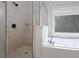 Well-lit bathroom featuring a glass shower, a soaking tub, and decorative tiles and a stained glass window at 2174 Basque Se Dr, Smyrna, GA 30080