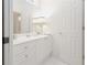 Bathroom vanity with white cabinets, quartz countertop, and decorative lamps for soft lighting at 2174 Basque Se Dr, Smyrna, GA 30080