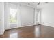Bright bedroom featuring hardwood floors, a ceiling fan, and beautiful patterned wallpaper at 2174 Basque Se Dr, Smyrna, GA 30080