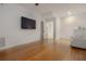 Bedroom features hardwood floors, and a television mounted on the wall at 2174 Basque Se Dr, Smyrna, GA 30080