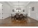 Elegant dining room with hardwood floors, tray ceiling, chandelier, and wainscoting at 2174 Basque Se Dr, Smyrna, GA 30080