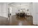 Dining room featuring hardwood floors, tray ceiling, chandelier, and seating for eight at 2174 Basque Se Dr, Smyrna, GA 30080