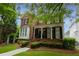 Charming two-story brick home with a welcoming front porch and beautifully landscaped front yard at 2174 Basque Se Dr, Smyrna, GA 30080