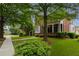 Charming two-story brick home with a welcoming front porch and beautifully landscaped front yard at 2174 Basque Se Dr, Smyrna, GA 30080