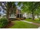 Charming two-story brick home with a welcoming front porch and beautifully landscaped front yard at 2174 Basque Se Dr, Smyrna, GA 30080