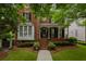 Charming two-story brick home with a welcoming front porch and beautifully landscaped front yard at 2174 Basque Se Dr, Smyrna, GA 30080