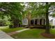 Charming two-story brick home with a welcoming front porch and beautifully landscaped front yard at 2174 Basque Se Dr, Smyrna, GA 30080