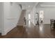 Spacious foyer with hardwood floors, white trim, staircase, and views to other rooms at 2174 Basque Se Dr, Smyrna, GA 30080